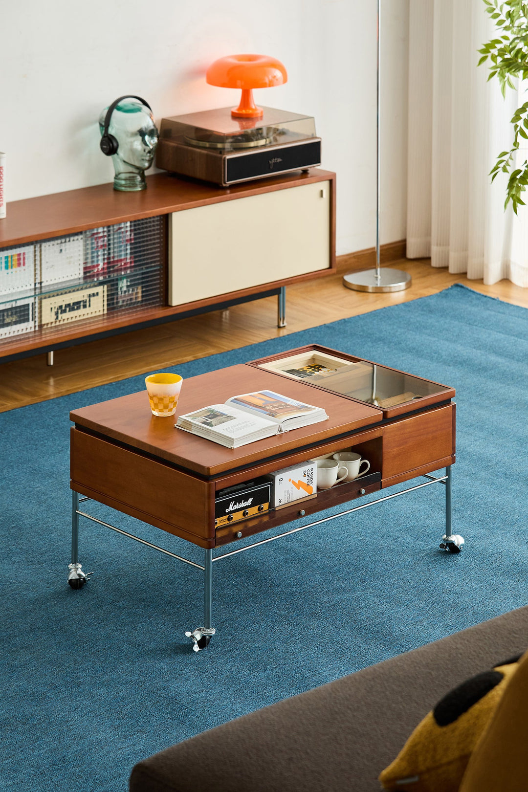 Bauhaus-inspired wooden coffee table with caster wheels and storage, ideal for stylish and mobile living spaces.