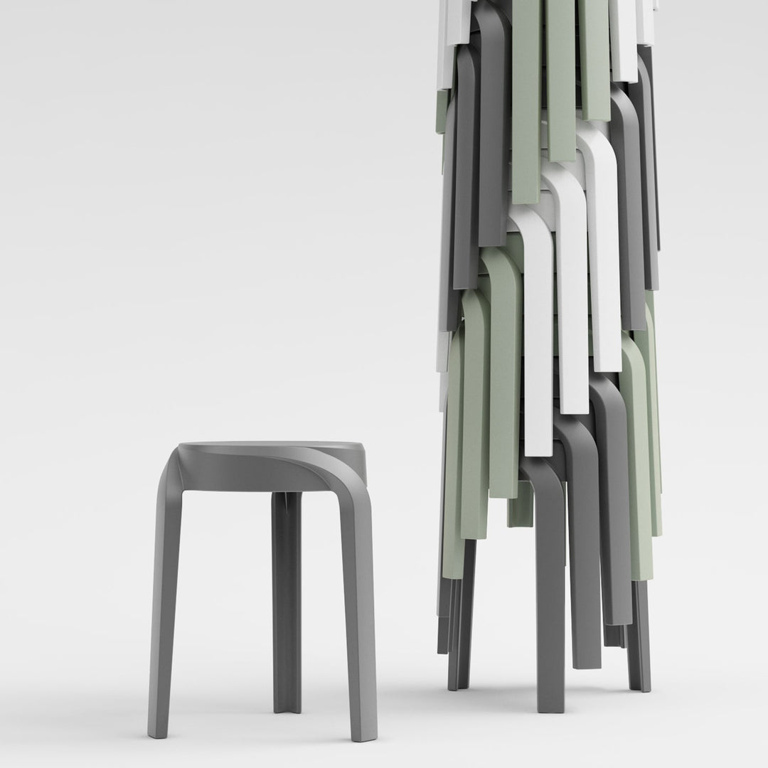 Minimalist stackable stools in grey and pastel green, featuring a space-saving design for versatile seating in modern spaces.