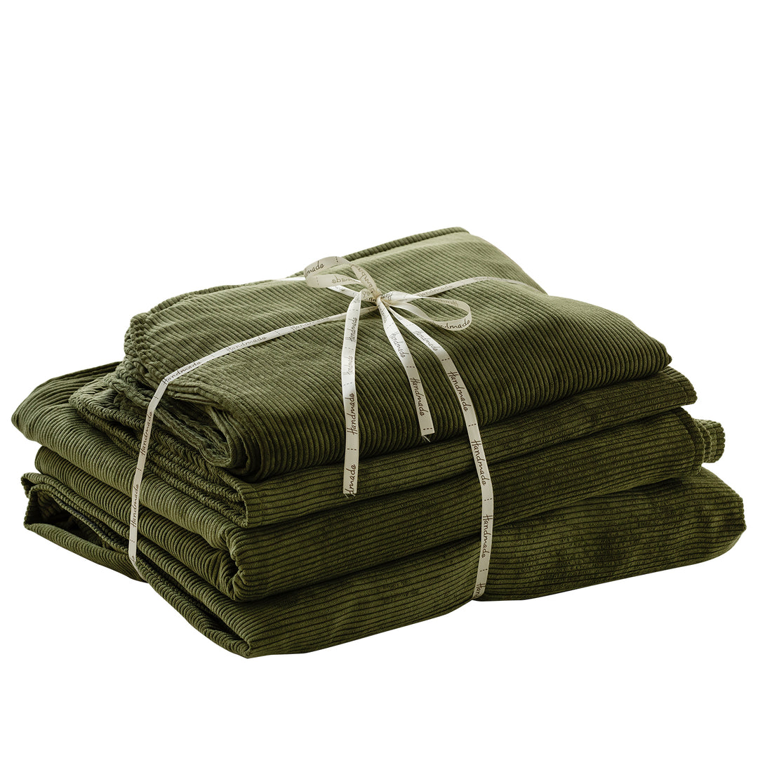 Stack of green towels tied with a white ribbon on a white background