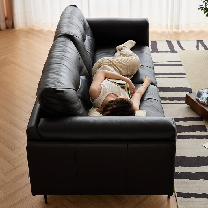 Scandinavian microfiber leather 4 seater sofa black in panoramic view.