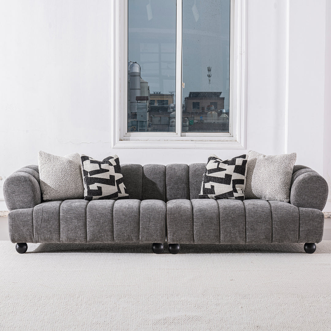 Modern velvet fabric sectional 4 seater sofa raven in still life.