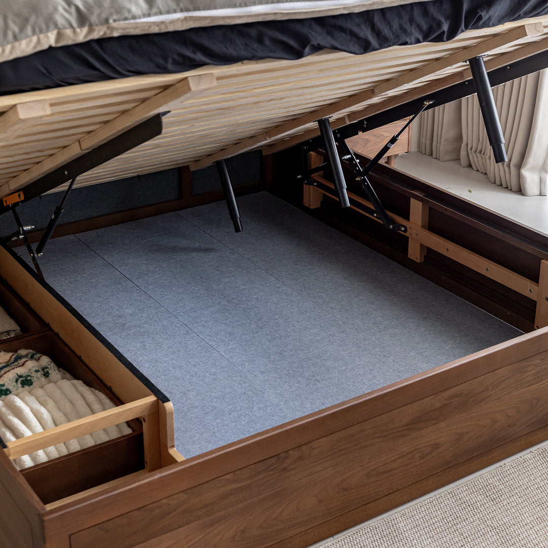 Vintage walnut wood lift-up storage platform bed with drawer kangaroo in still life.