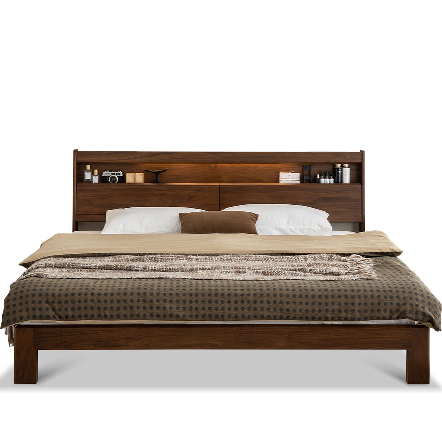 Wooden bed with bedding and headboard shelves on a white background