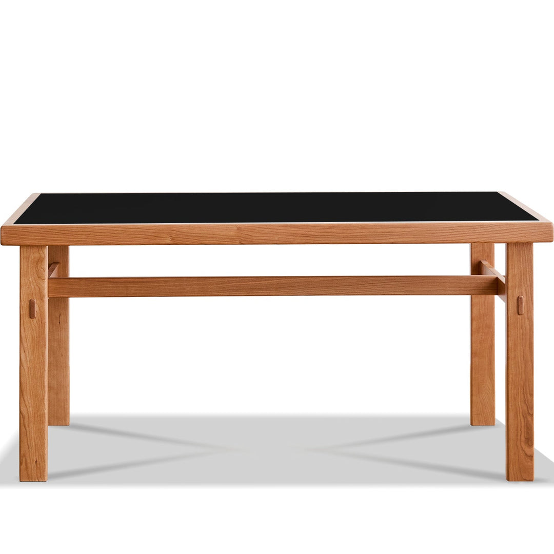 Wooden table with a black top on a white background