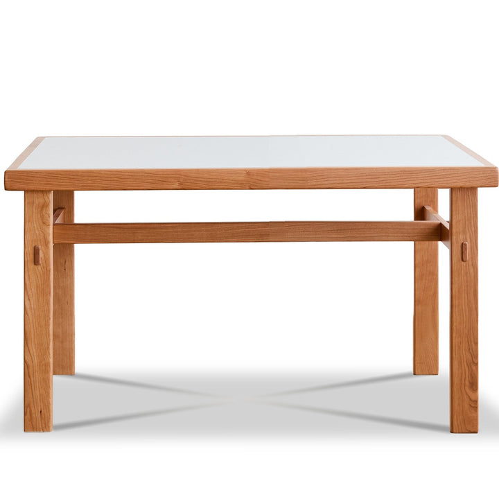 Wooden table with a white glass top on a white background