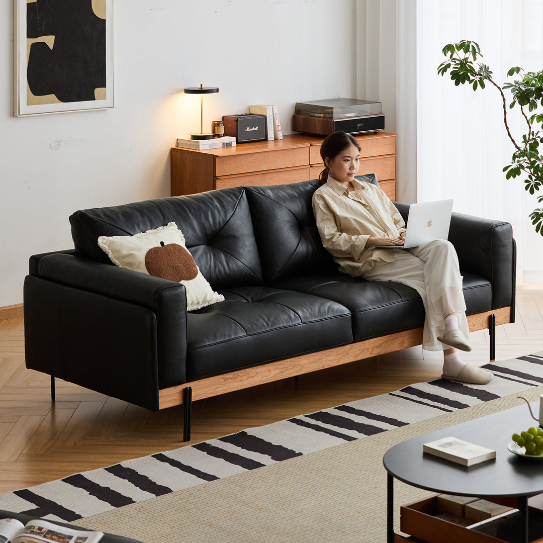 Scandinavian microfiber leather 4 seater sofa black in real life style.