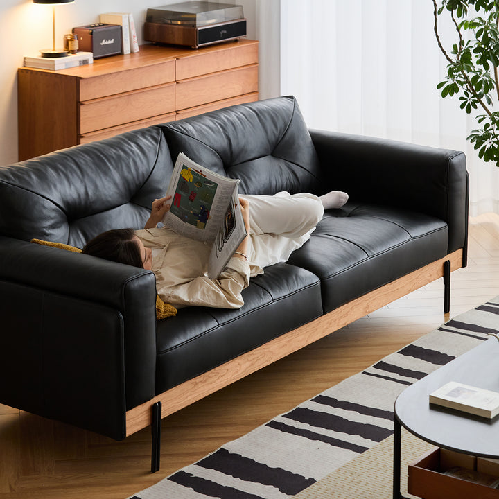 Scandinavian microfiber leather 3 seater sofa black with context.