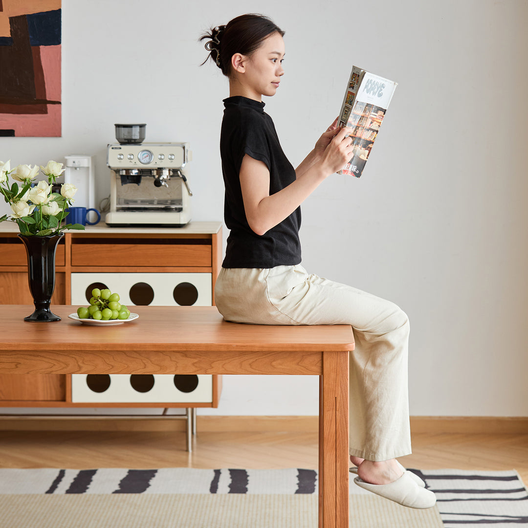 Scandinavian cherry wood dining table eclipse in close up details.