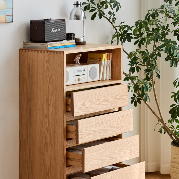 Scandinavian oak wood chest of 5 drawers floating light in close up details.