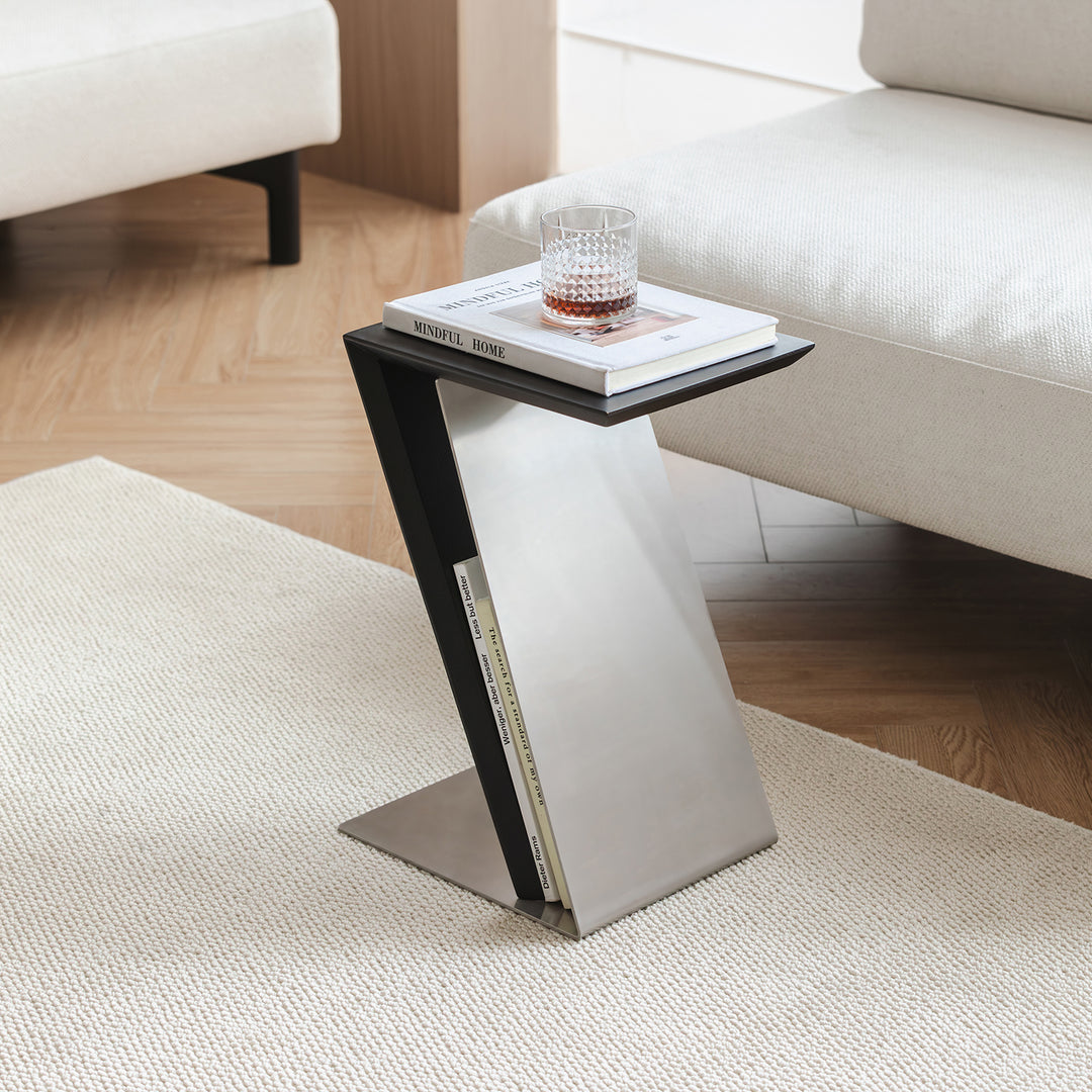 Minimalist stainless steel side table zig in close up details.