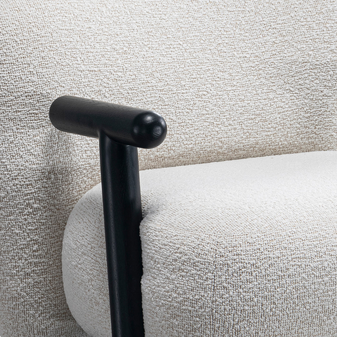 Cream boucle fabric 1 seater sofa with armrest malt with context.