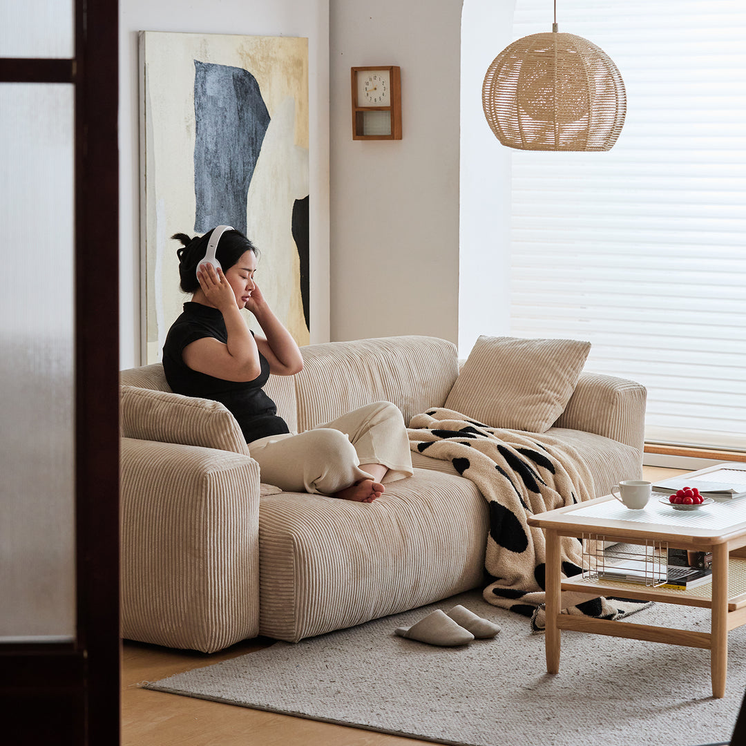 Cream corduroy velvet fabric 2 seater sofa square with context.