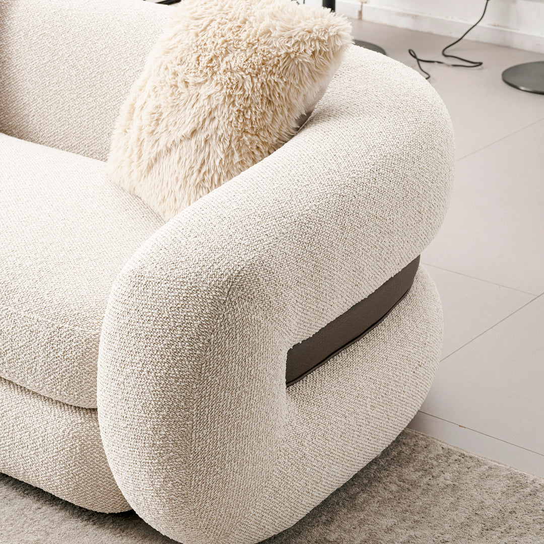 Cream boucle fabric 2 seater sofa curly with context.