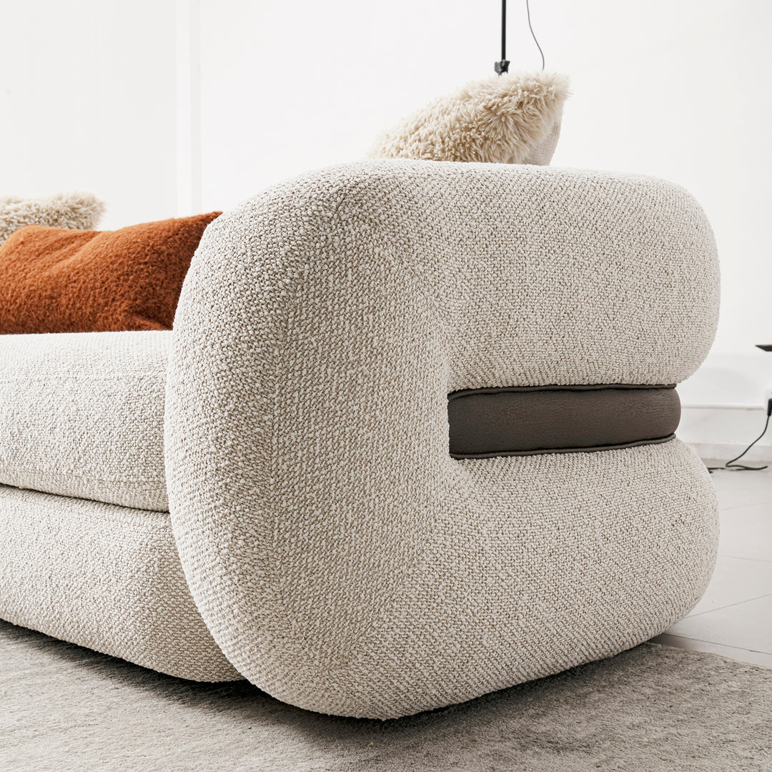 Cream boucle fabric 2 seater sofa curly in details.