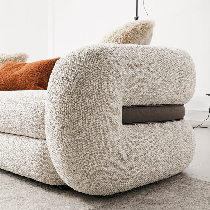 Cream boucle fabric 2 seater sofa curly in details.