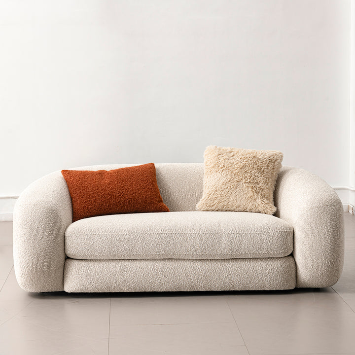 Cream boucle fabric 2 seater sofa curly in close up details.