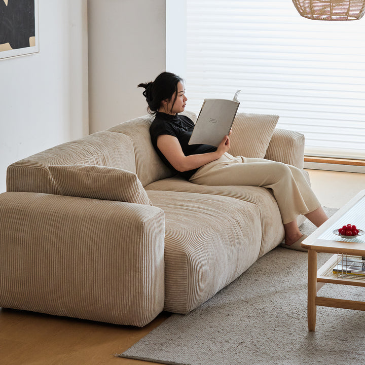 Cream corduroy velvet fabric 3 seater sofa square in panoramic view.