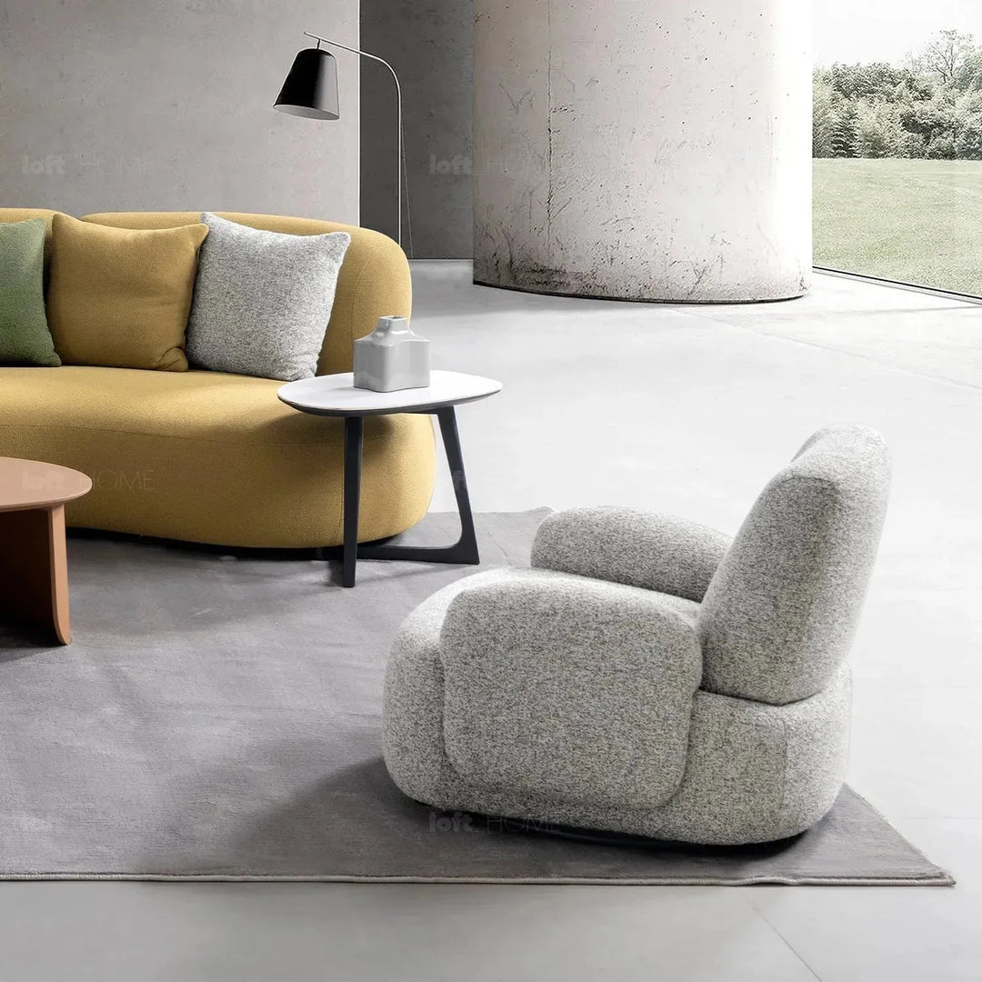 Cream mixed weave fabric revolving 1 seater sofa parapet in close up details.