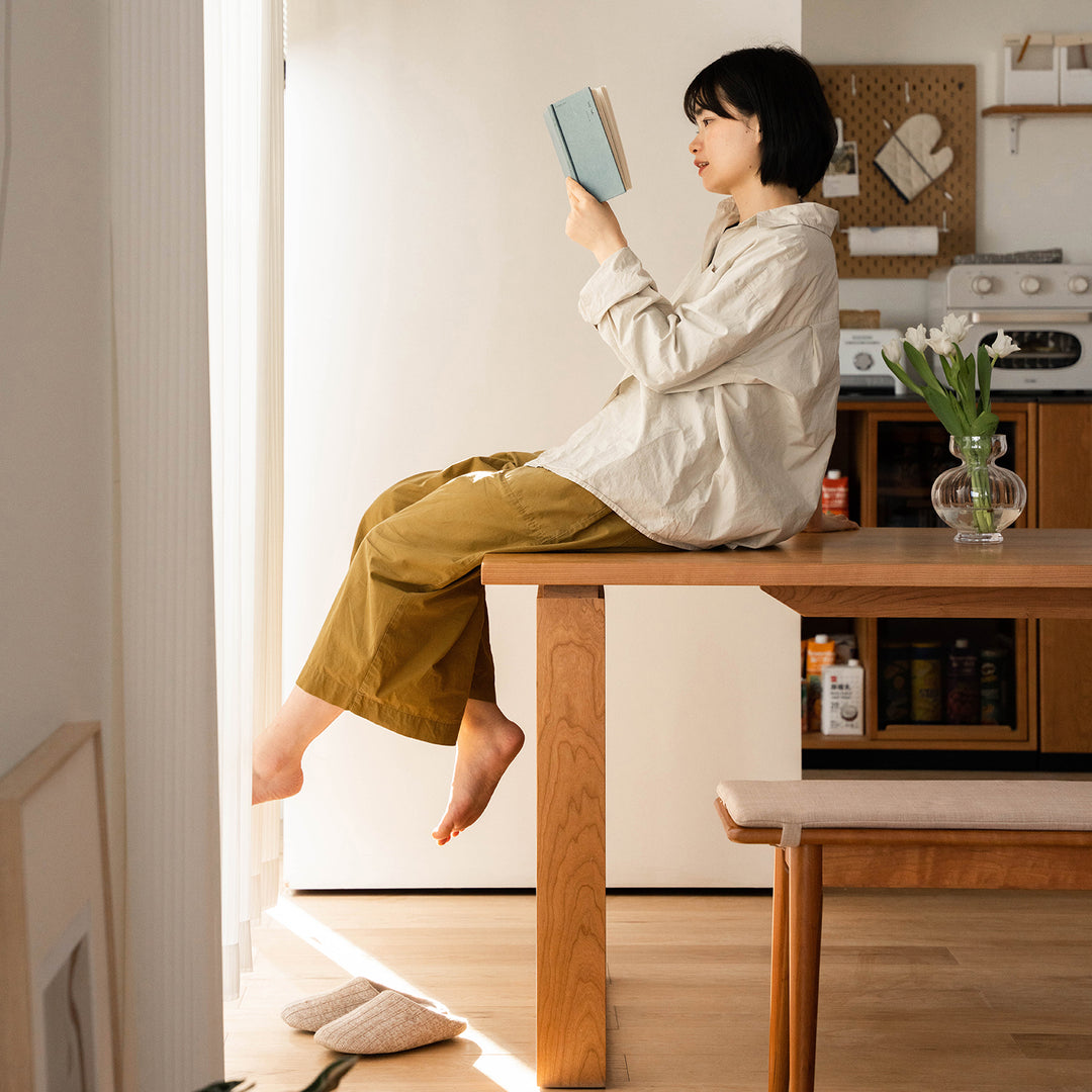 Scandinavian cherry wood dining table blue whale in close up details.