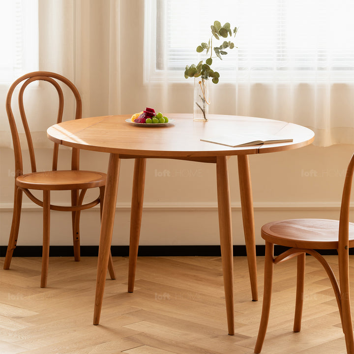 Scandinavian cherry wood extendable round dining table greekn primary product view.