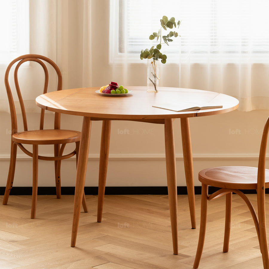 Scandinavian cherry wood extendable round dining table greekn primary product view.