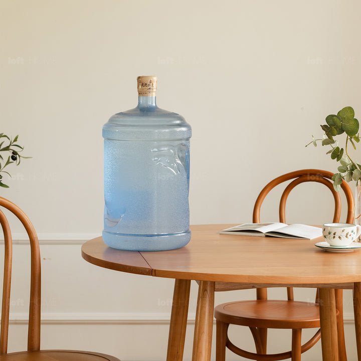 Scandinavian cherry wood extendable round dining table greekn in still life.