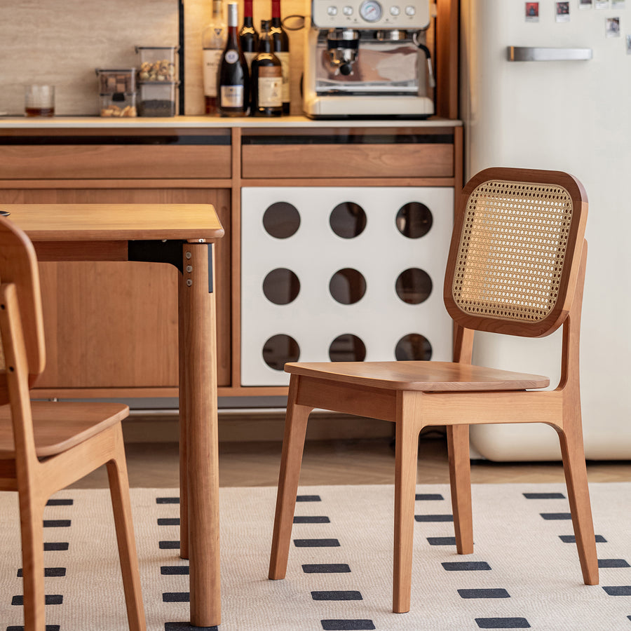 Scandinavian cherry wood rattan dining chair nook in details.