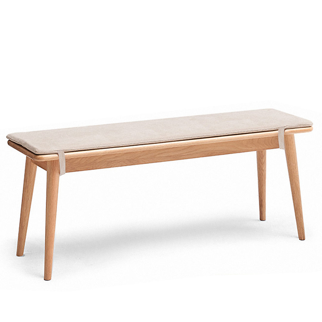 Scandinavian oak wood dining bench with cushion sereno in white background.