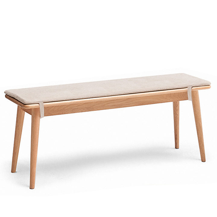 Scandinavian oak wood dining bench with cushion sereno in white background.