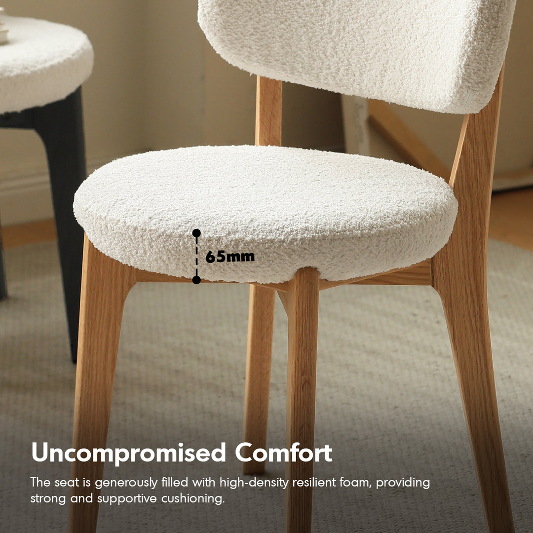 Scandinavian oak wood boucle fabric cover removable dining chair cloud in close up details.