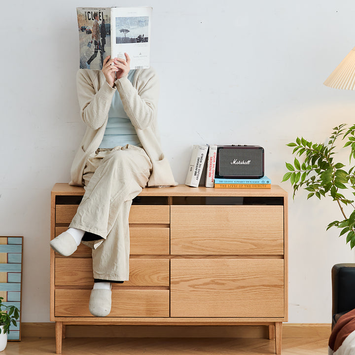 Scandinavian oak wood chest of 6 drawers floating light in close up details.