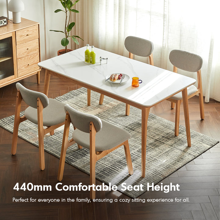 Scandinavian oak wood mixed weave fabric cover removable dining chair nest in still life.