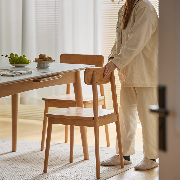 Scandinavian cherry wood dining chair green in close up details.