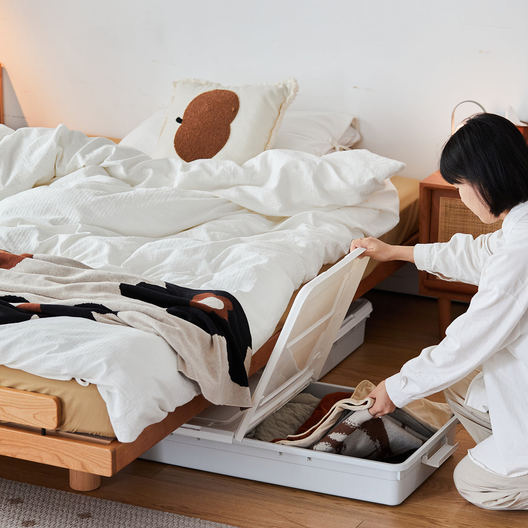 Scandinavian cherry wood platform bed small in still life.