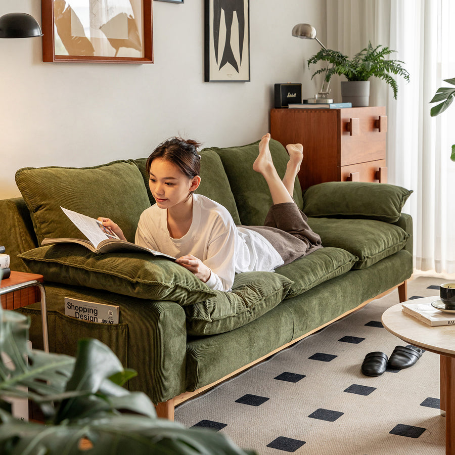 Scandinavian corduroy velvet fabric 3 seater sofa indigo with context.