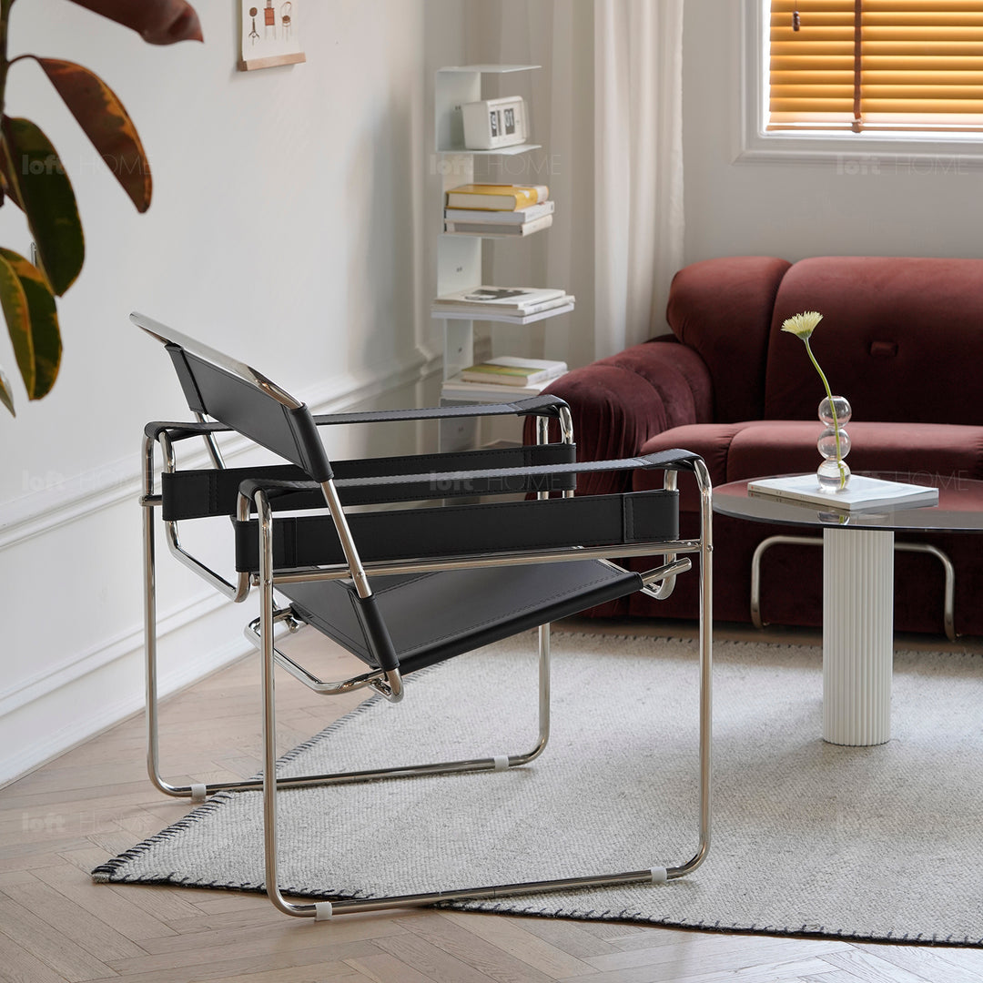 Vintage steel leather sofa chair 1 seater sofa wassily in panoramic view.