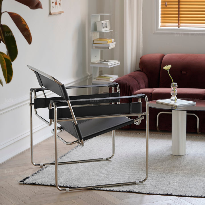 Vintage steel leather sofa chair 1 seater sofa wassily in panoramic view.