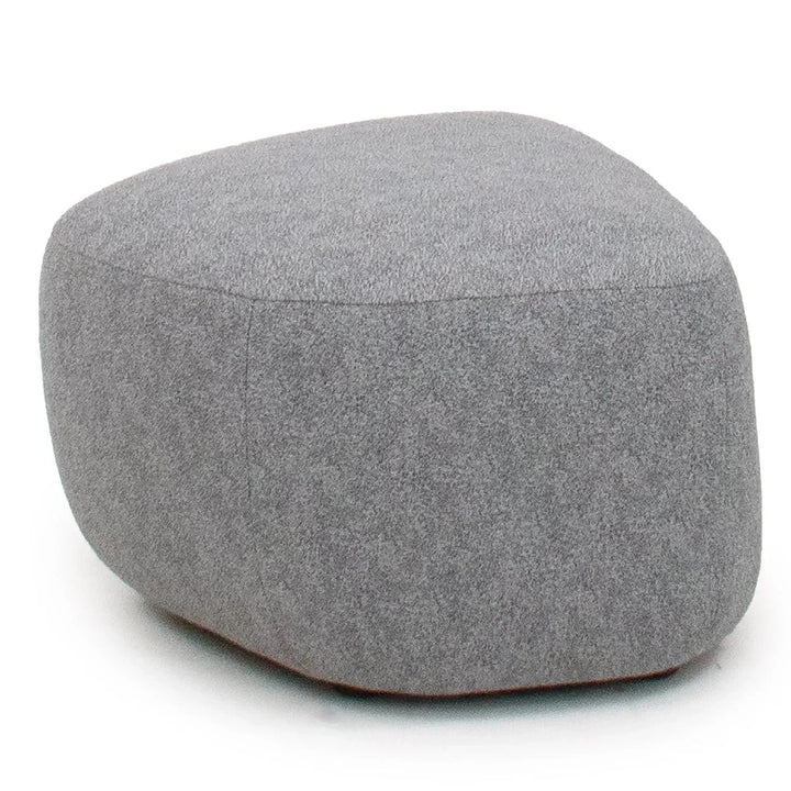 Contemporary fabric ottoman pebble in white background.