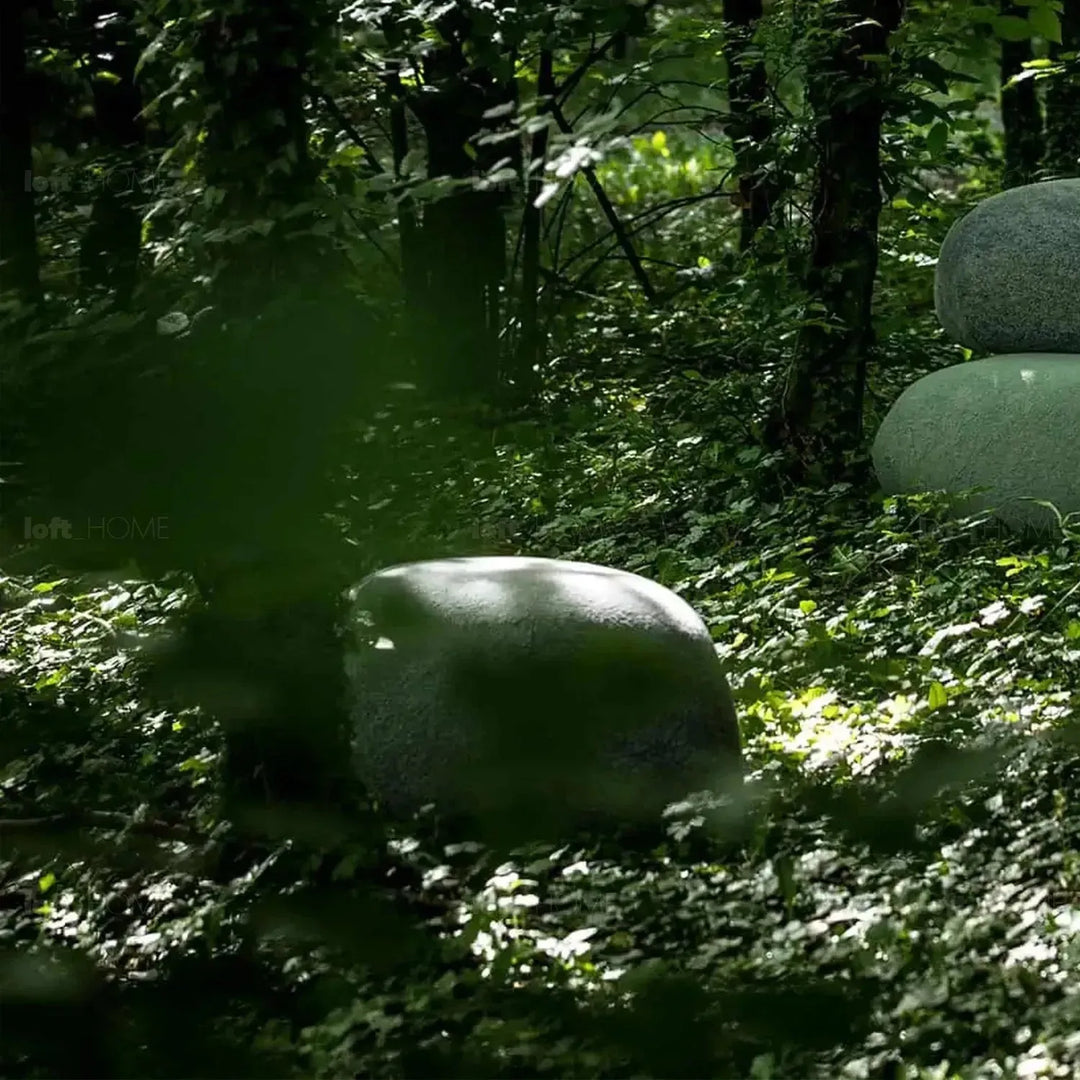 Contemporary fabric ottoman pebble with context.