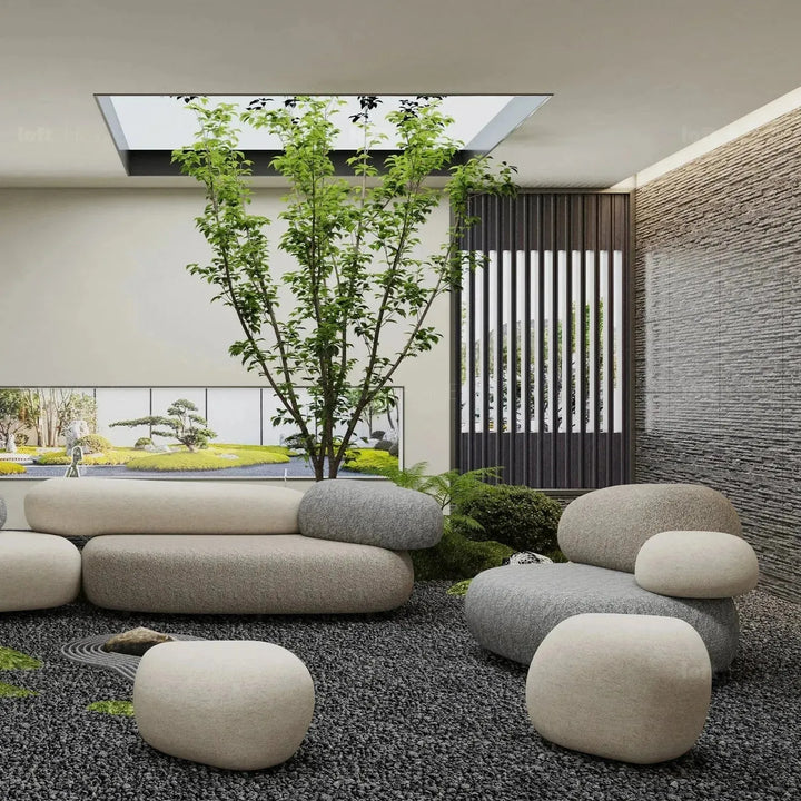 Contemporary fabric ottoman pebble in still life.