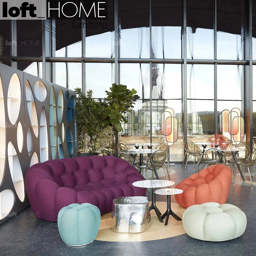 Contemporary fabric round ottoman bubble in panoramic view.
