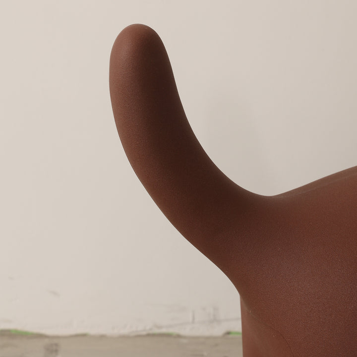 Contemporary plastic ottoman cat with context.