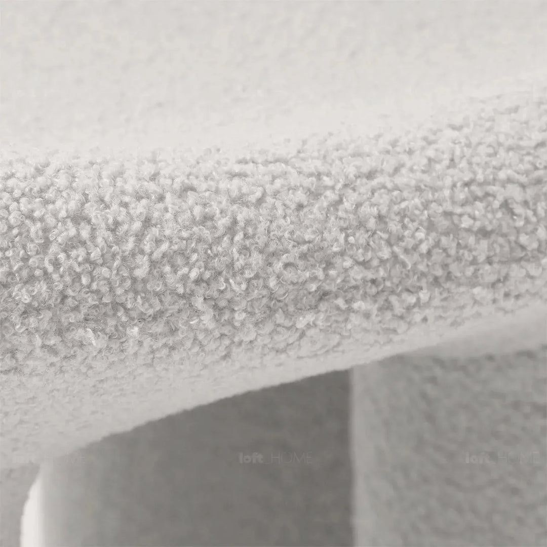 Cream boucle 1 seater sofa mibster in details.