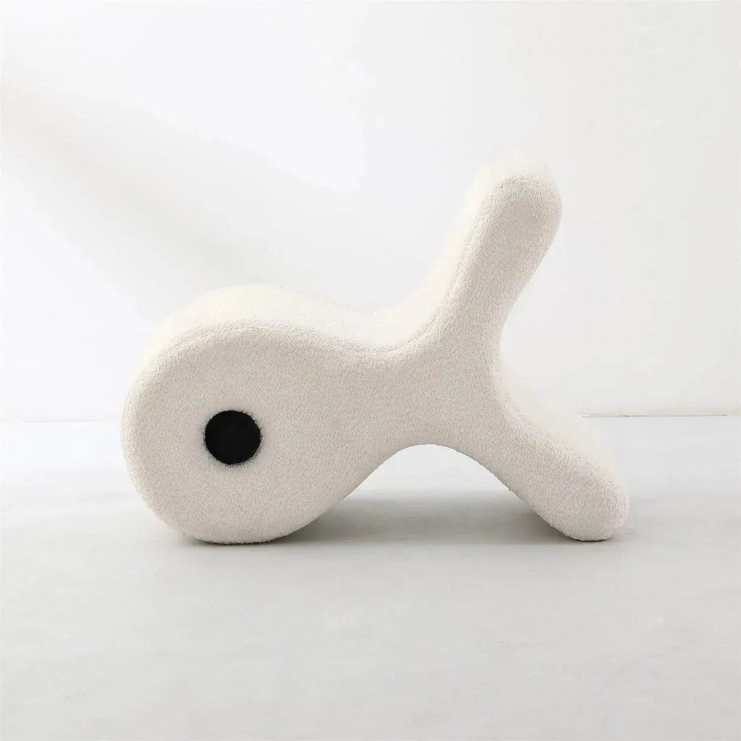 Cream boucle ottoman fish in still life.