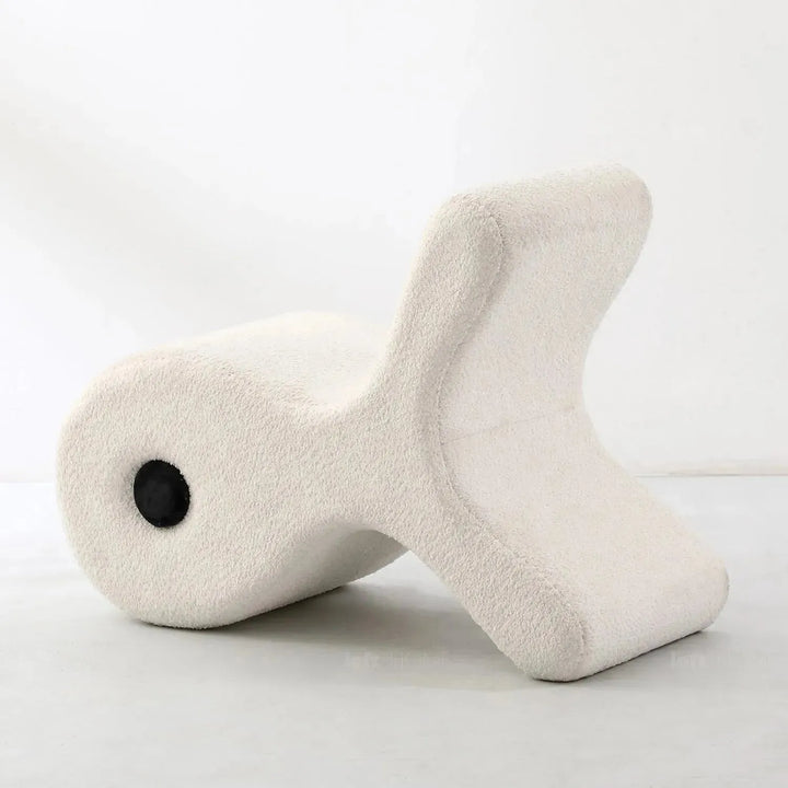 Cream boucle ottoman fish in panoramic view.