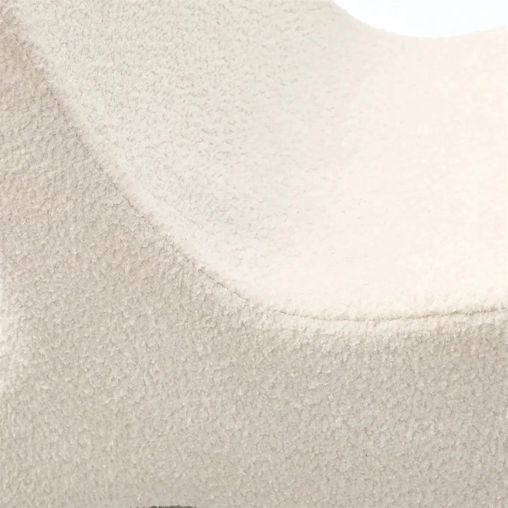 Cream boucle ottoman fish layered structure.