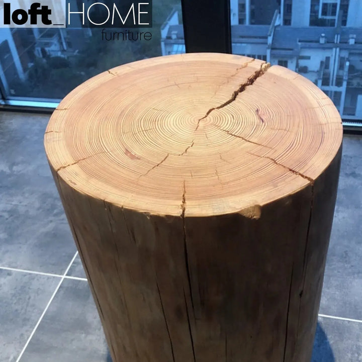 Rustic wood side table stump in panoramic view.