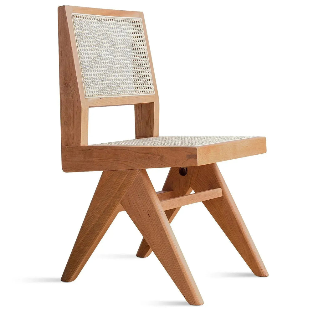 Scandinavian rattan dining chair jeanneret in white background.