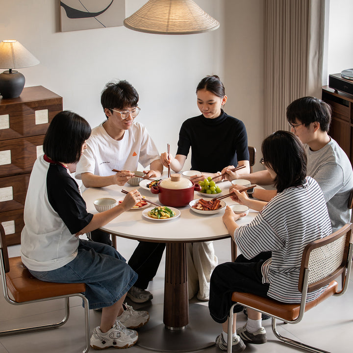 Japandi walnut wood sintered stone round dining table grey in details.