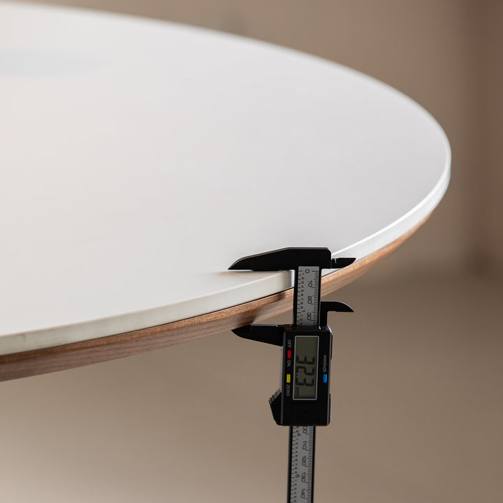 Japandi walnut wood sintered stone round dining table grey in close up details.